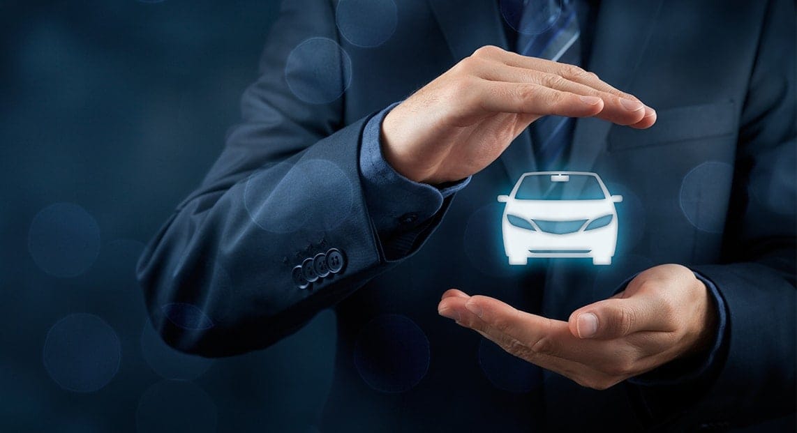 a person's hands holding a car