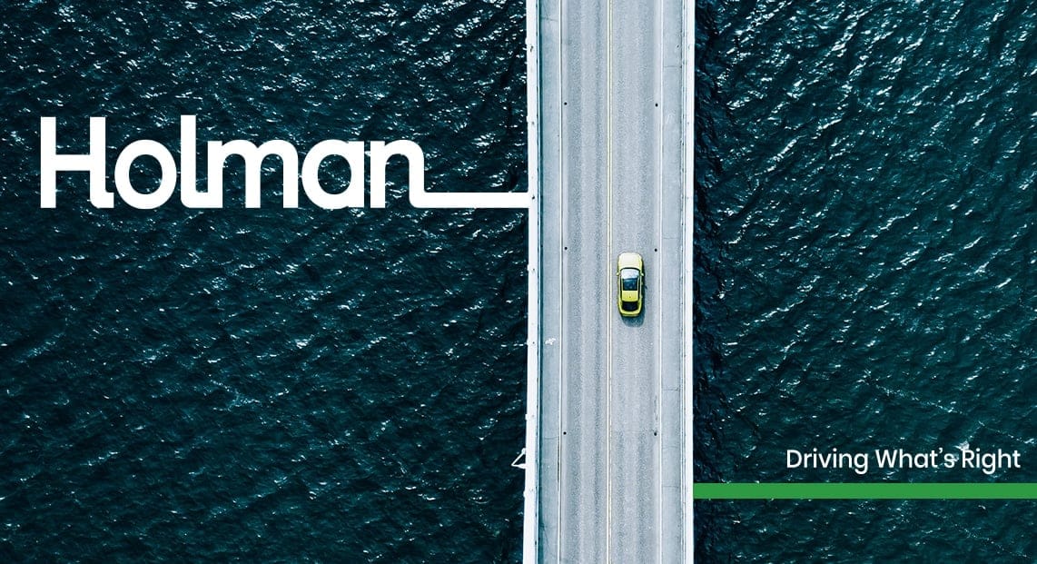 a car driving on a bridge over water