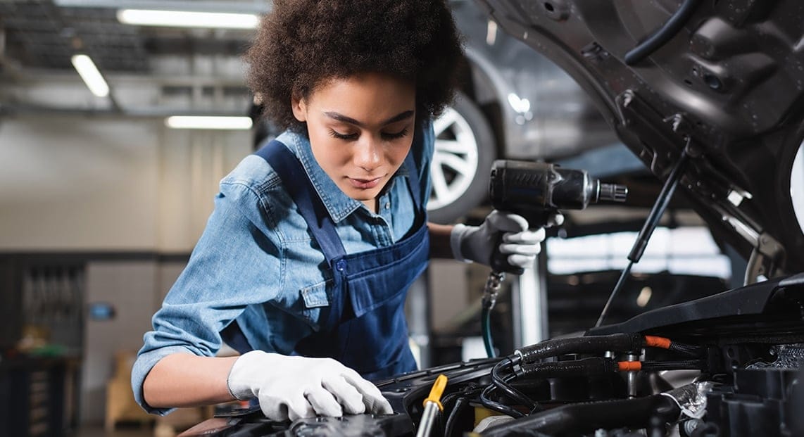a woman working on a car