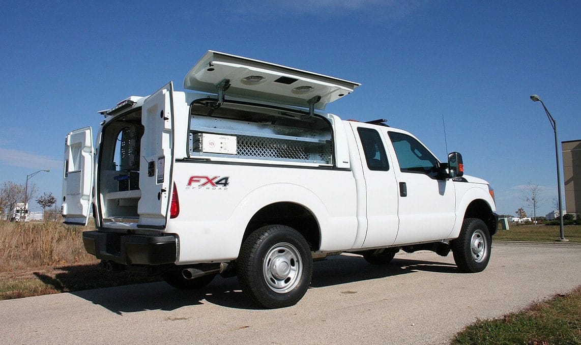 A white upfitted pickup truck