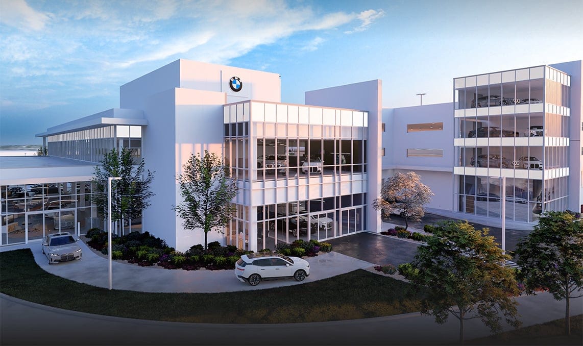 a white building with a car parked in front of it