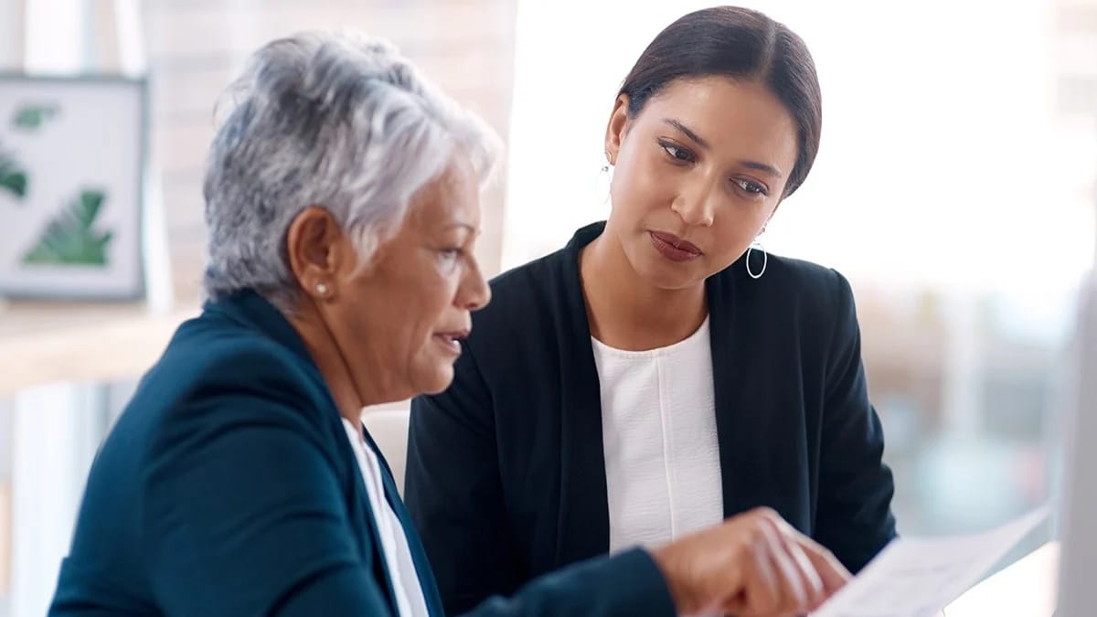 Two business professionals reviewing a document.