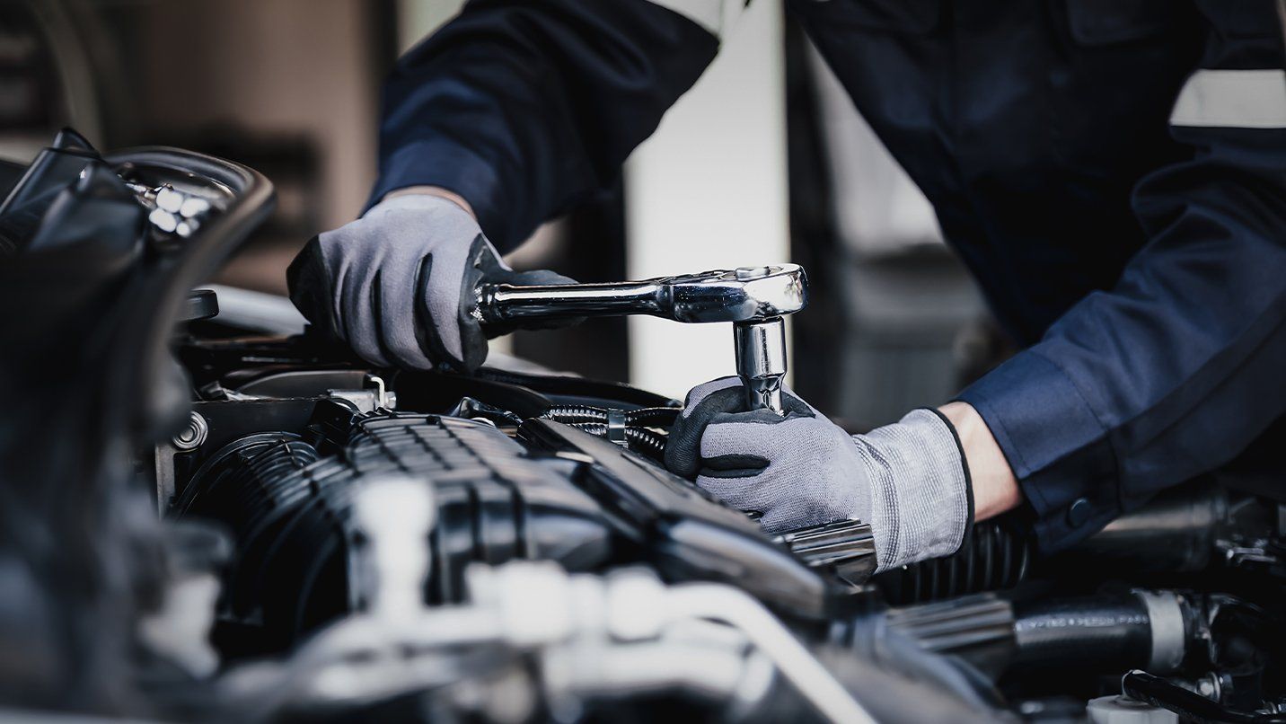 Mechanic using a socket set to work on a car