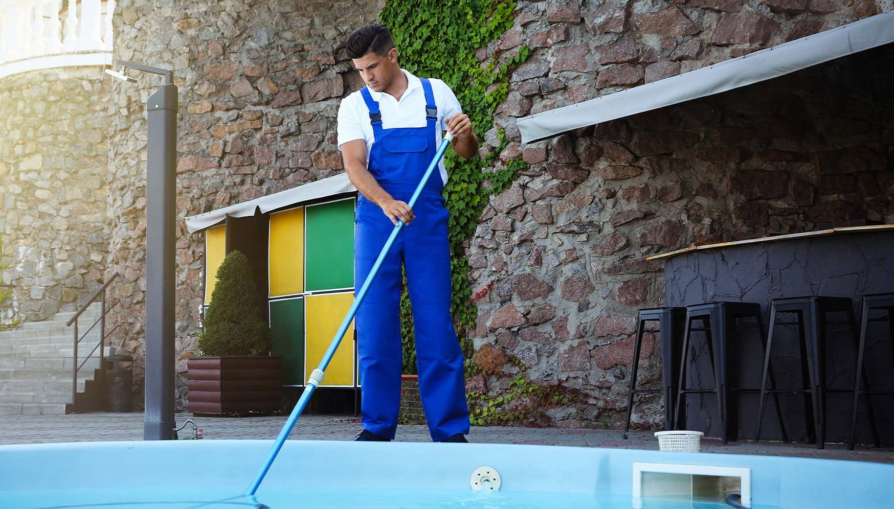 A man cleaning a pool