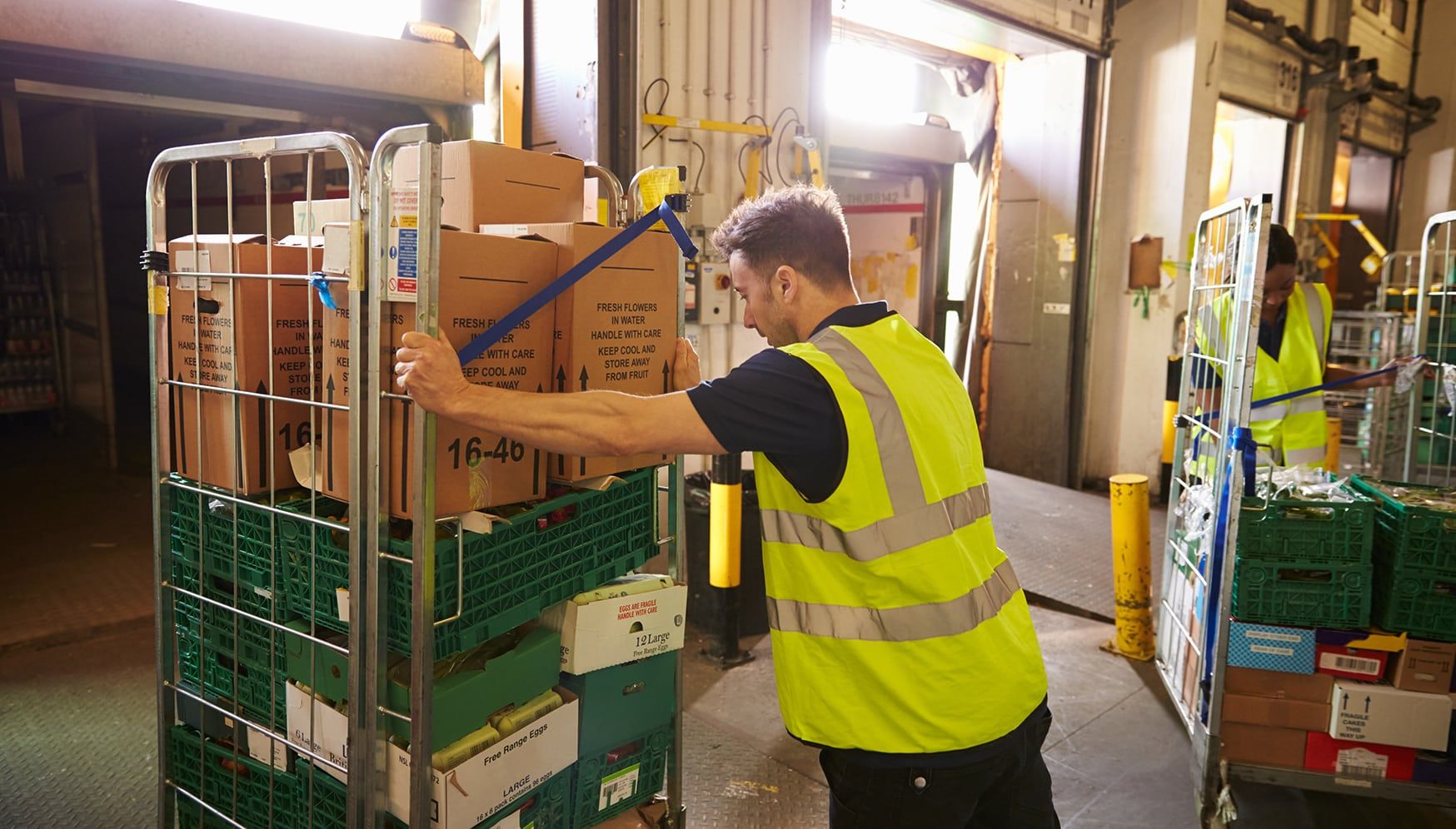 Man pushing a cart of boxes