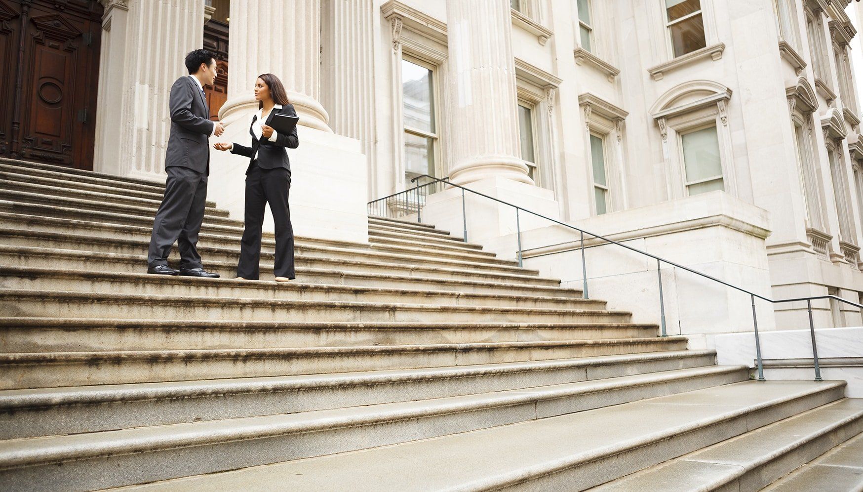 a man and woman talking on stairs