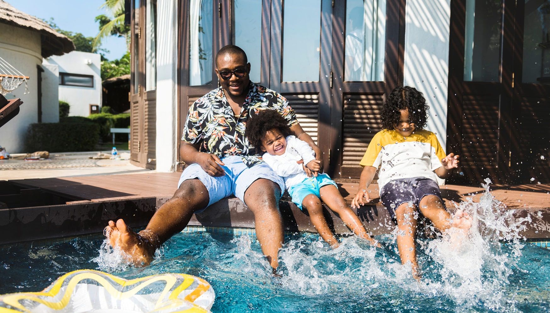 a man and children sitting in a pool