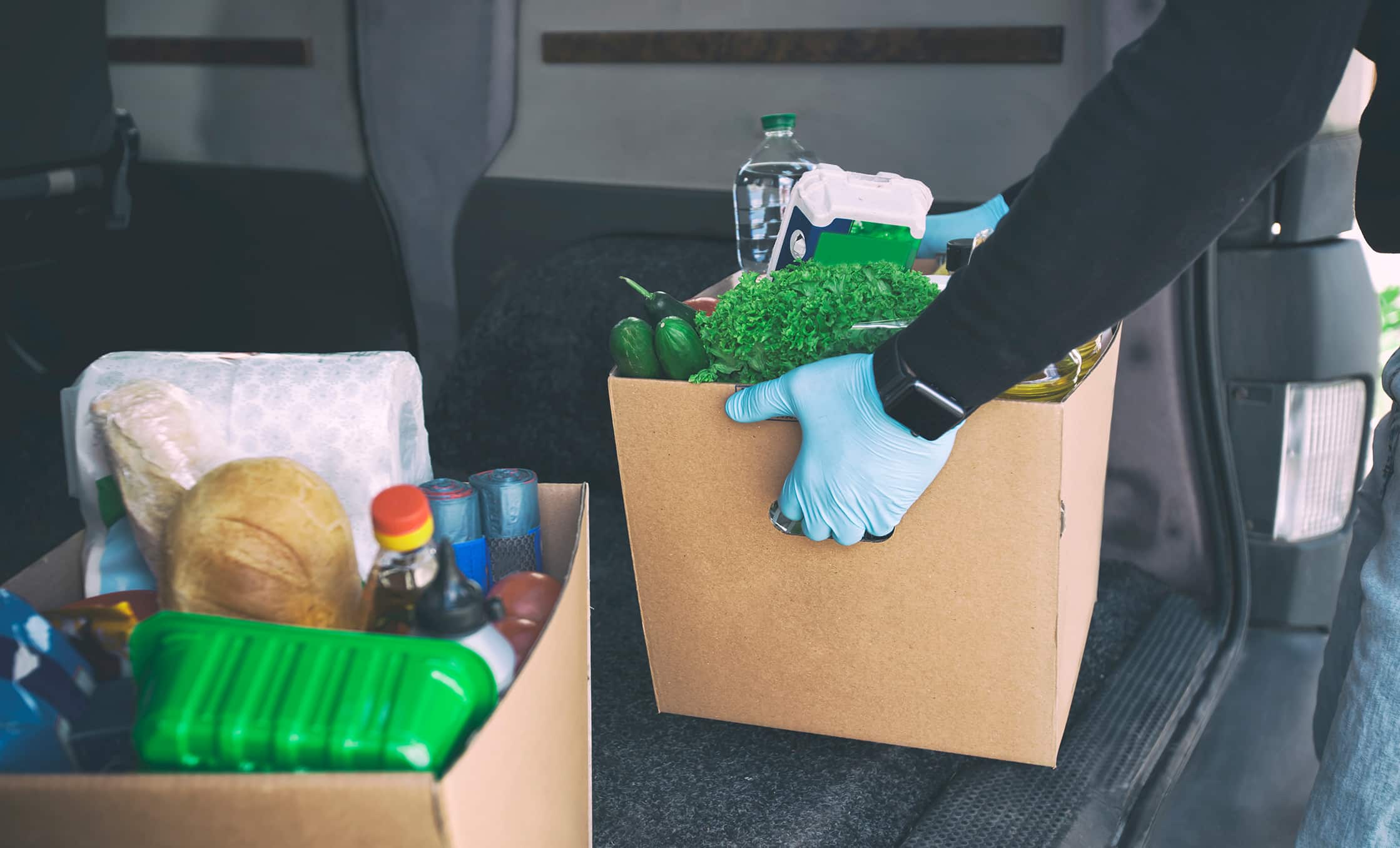 a person holding a box of food