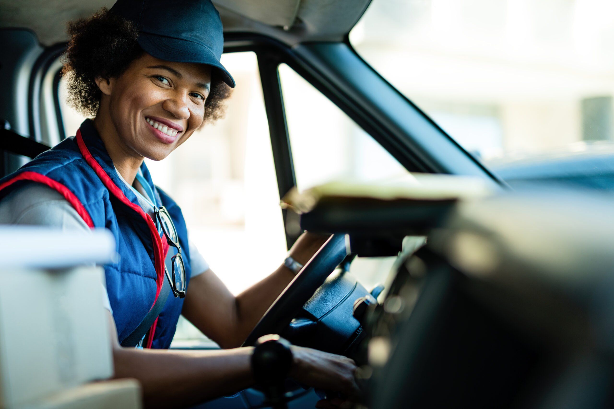 Woman smiling in in the van while holding the steering wheel