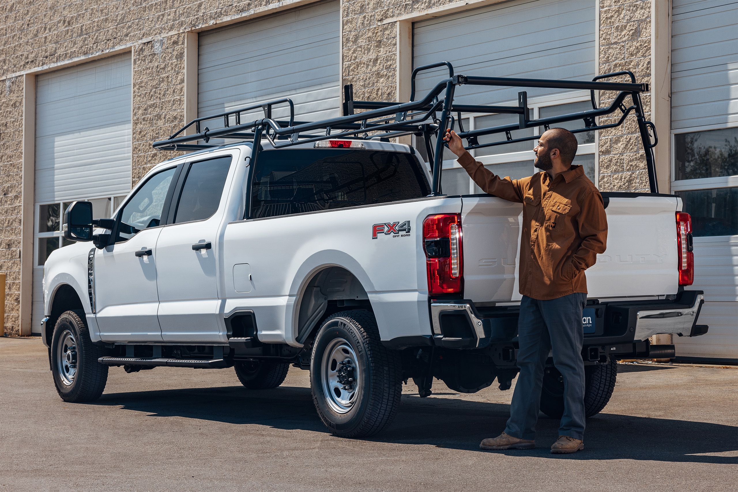 a man standing next to a white truck