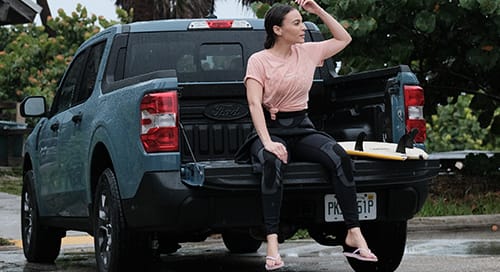 a woman sitting on the back of a truck