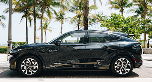 a black car parked on a brick road