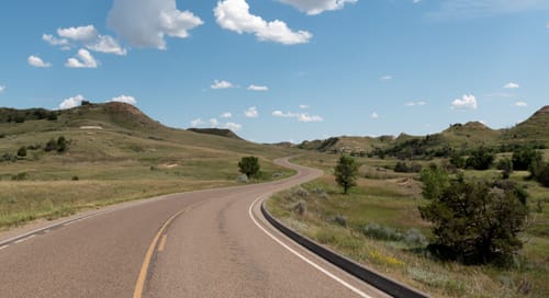 a road going through a grassy area