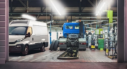 a group of vehicles in a garage