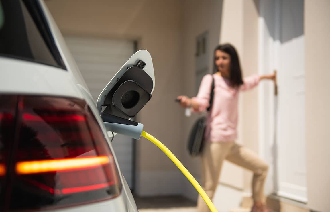 a woman standing in front of a car