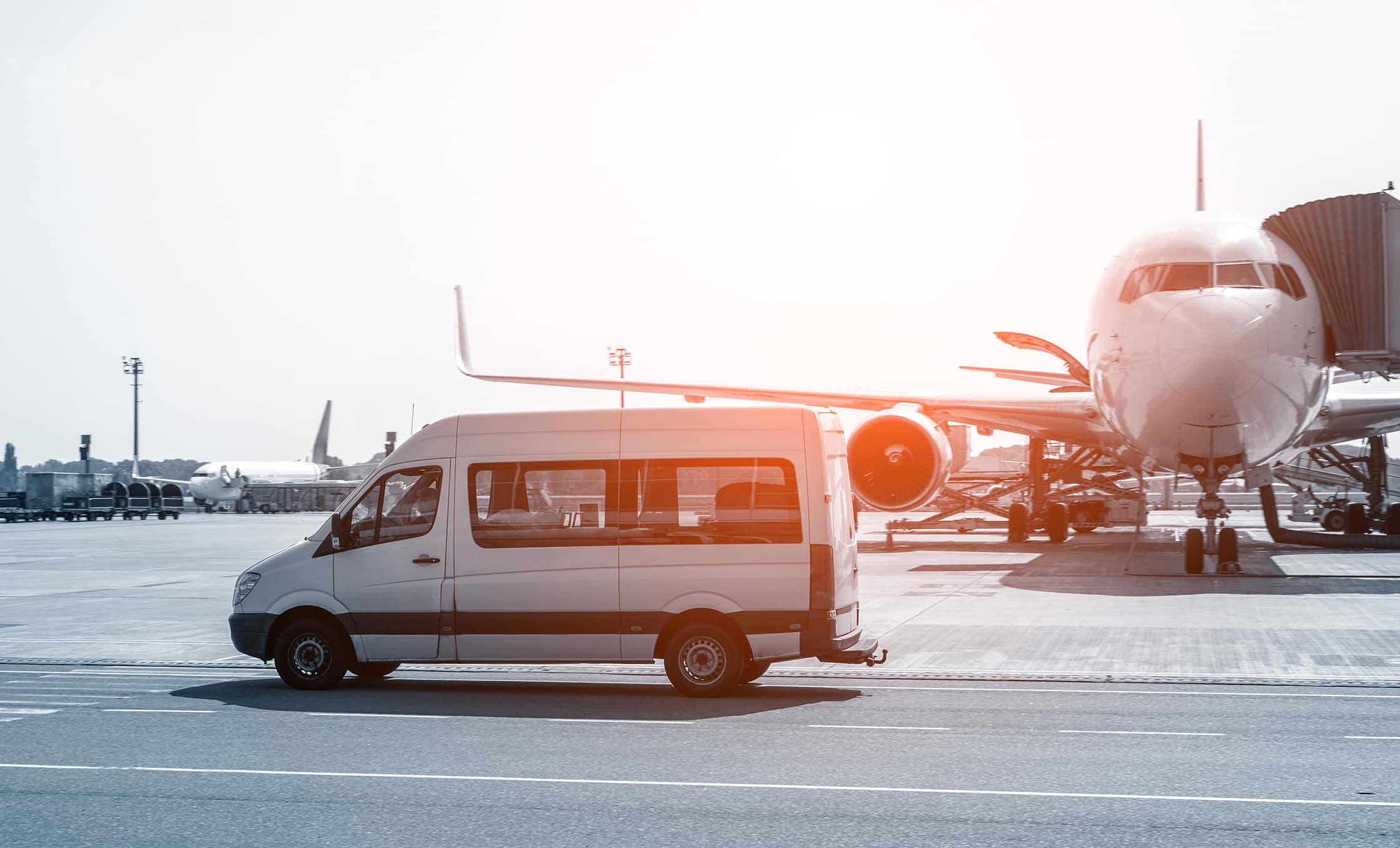 a van and an airplane on a runway