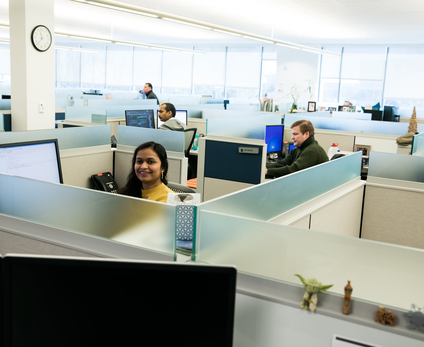 a group of people in cubicles